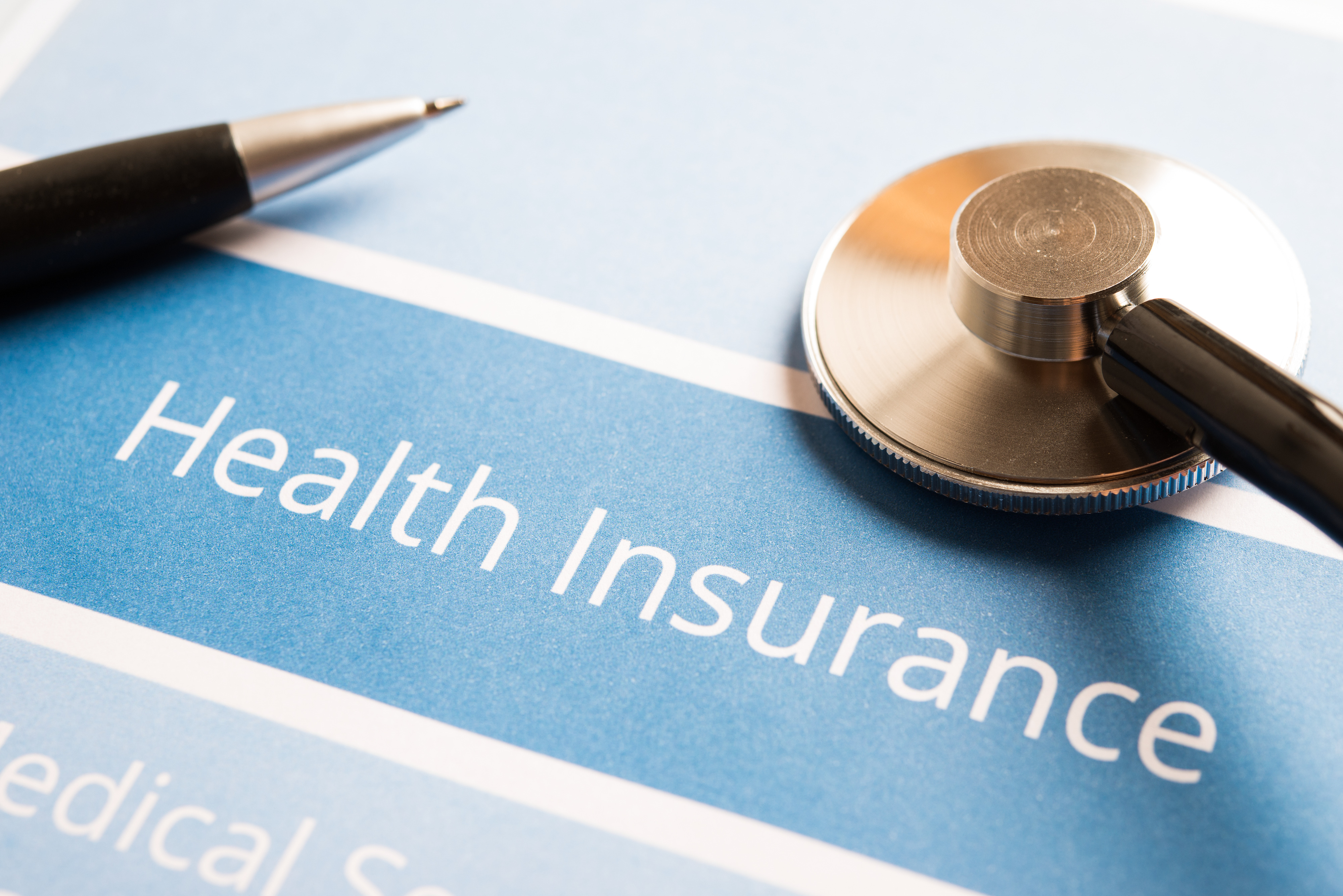 Health Insurance With Pen On Top